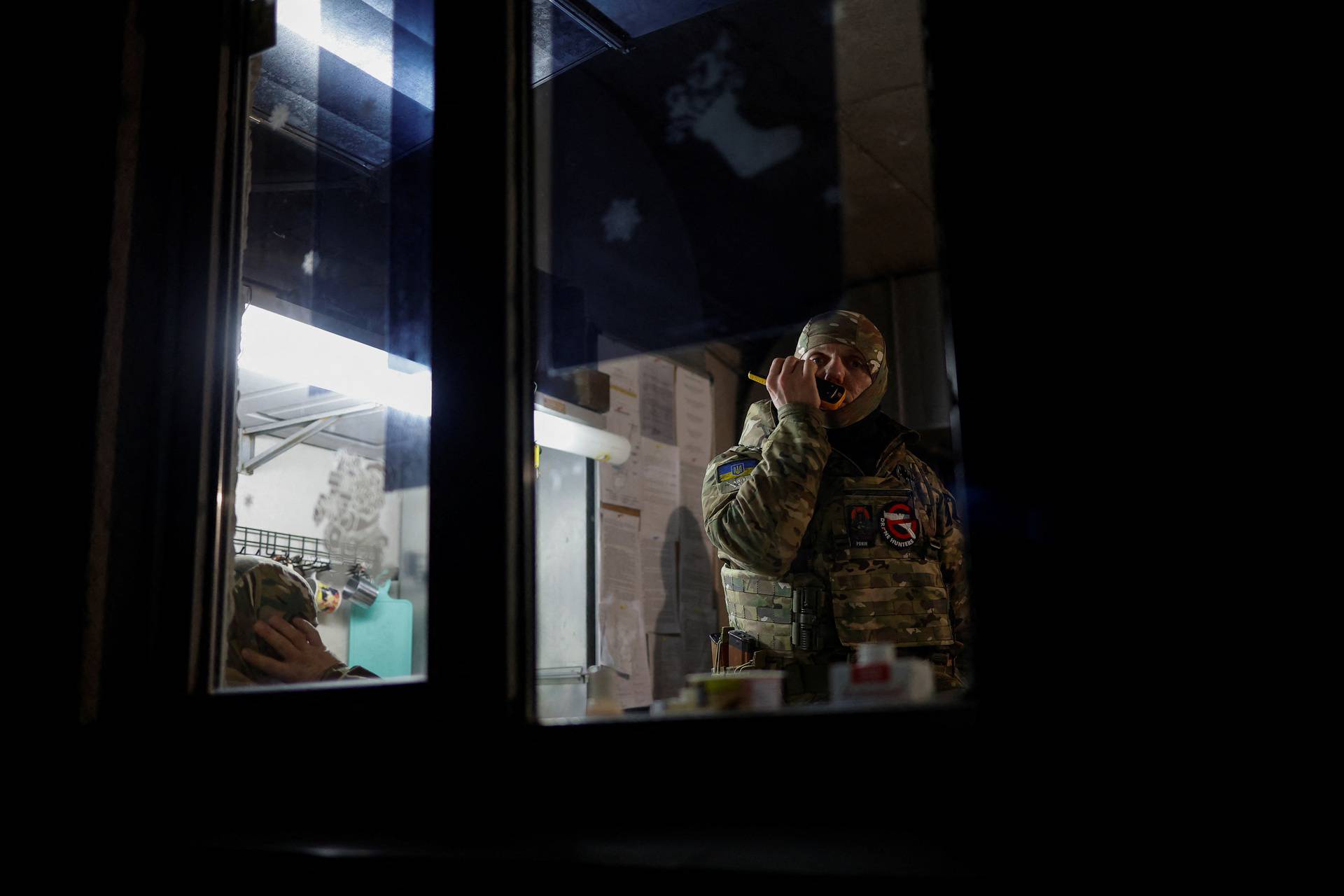 Hairdresser and Ukrainian Territorial Defence unit volunteer works at a beauty salon, in Kyiv