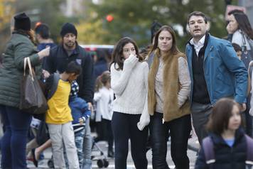 Parents pick up their children from P.S./I.S.-89 school after a shooting incident in New York City