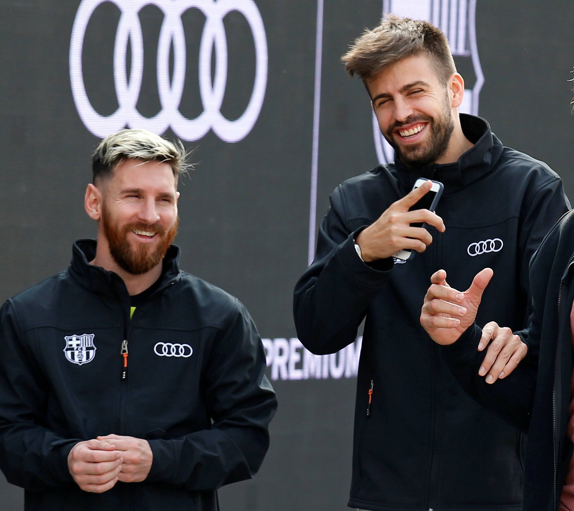 Barcelona's soccer players Messi and Pique take part in a commercial event near Camp Nou stadium in Barcelona