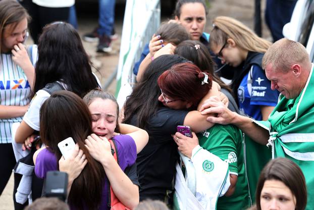 Fans of Chapecoense soccer team react in front of the Arena Conda stadium in Chapeco
