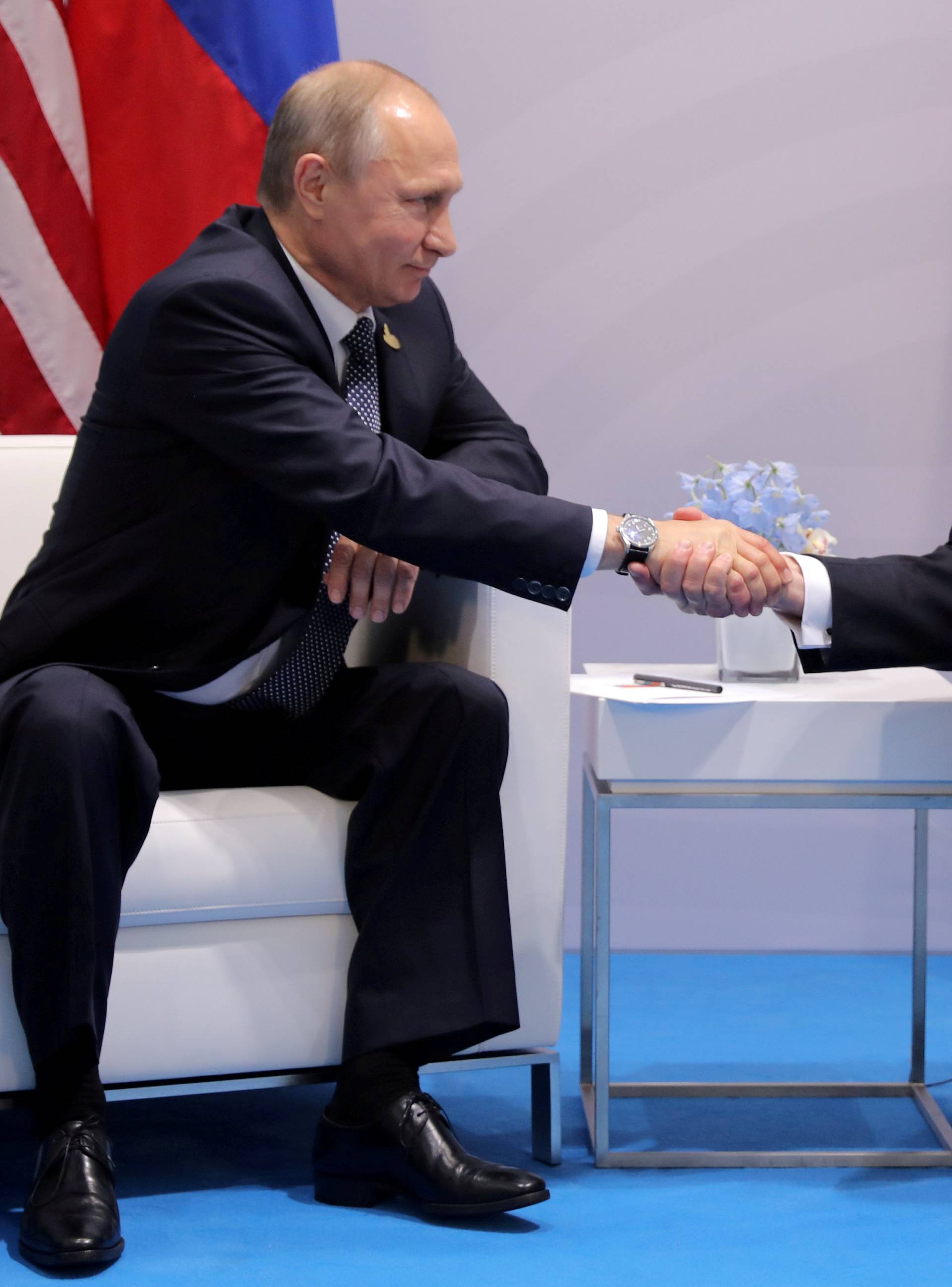 FILE PHOTO: U.S. President Donald Trump shakes hands with Russia's President Vladimir Putin during the their bilateral meeting at the G20 summit in Hamburg