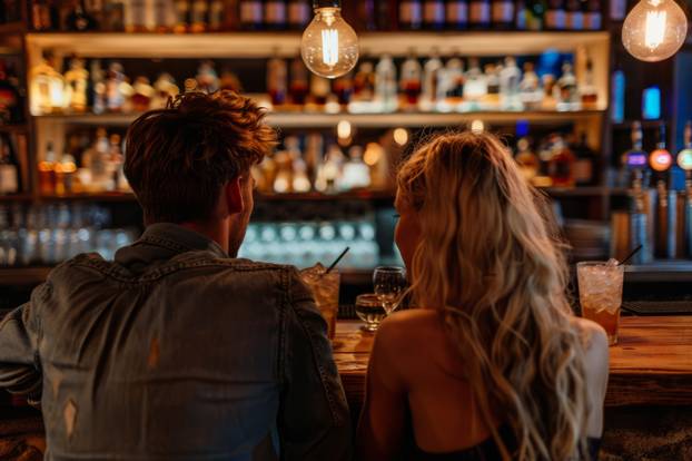 Man sitting next to a blonde woman at a bar and drinking alcohol. Generative AI