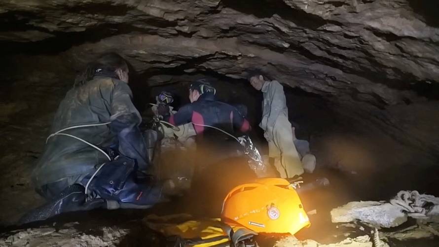 Rescue divers share the equipment usage guidelines with people trapped inside a cave during their rescue mission in Xaisomboun Province
