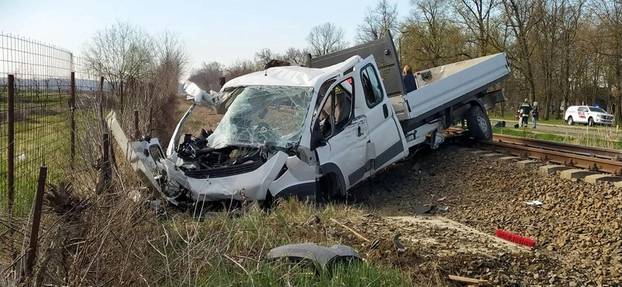 A damaged pick-up truck is seen at a scene of an accident where it crashed into a train in Mindszent