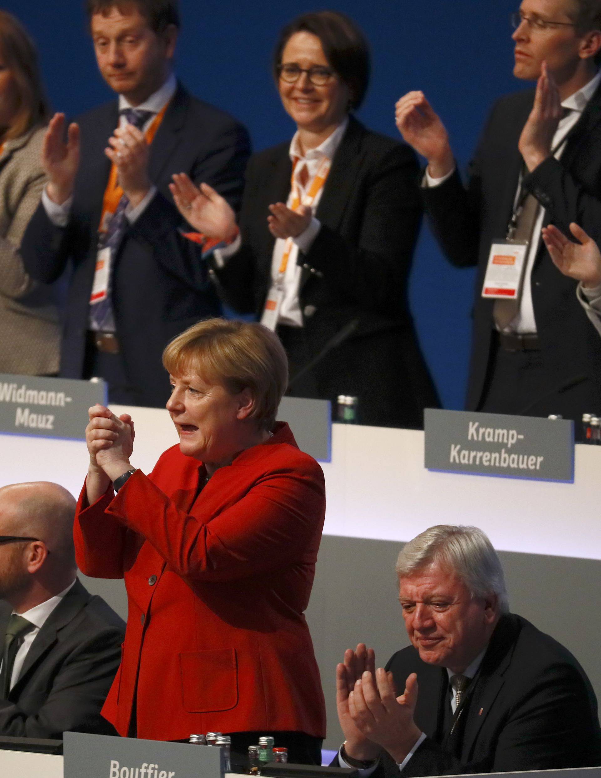 German Chancellor and leader of the conservative CDU Merkel reacts after her speech at the CDU party convention in Essen