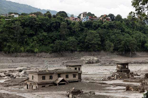Mud covers buildings following a flash flood at Trishuli, Nepal