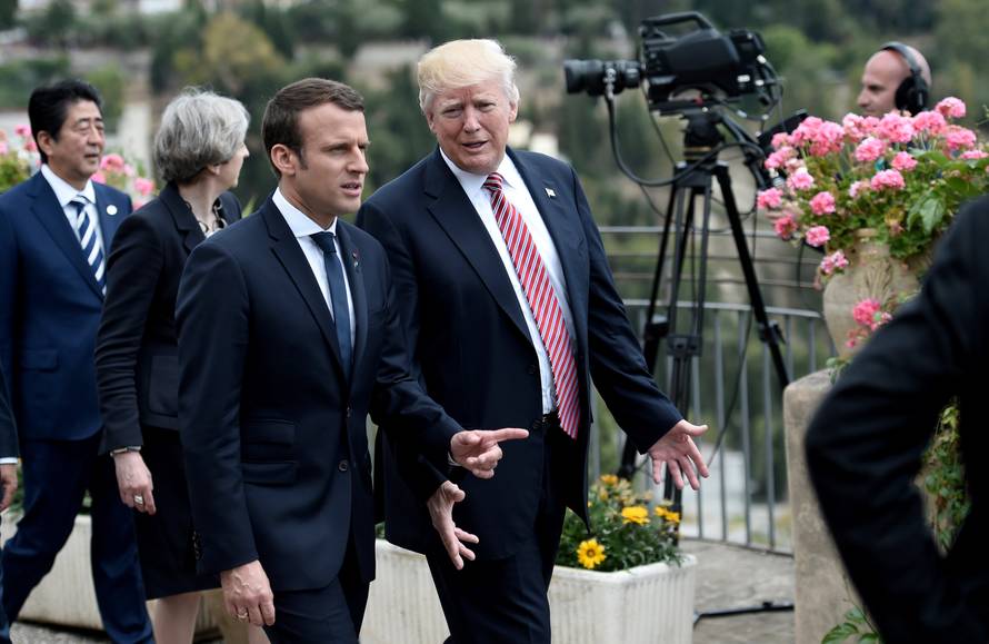 U.S. President Donald Trump talks with French President Emmanuel Macron as they attend the G7 Summit in Taormina, Sicily