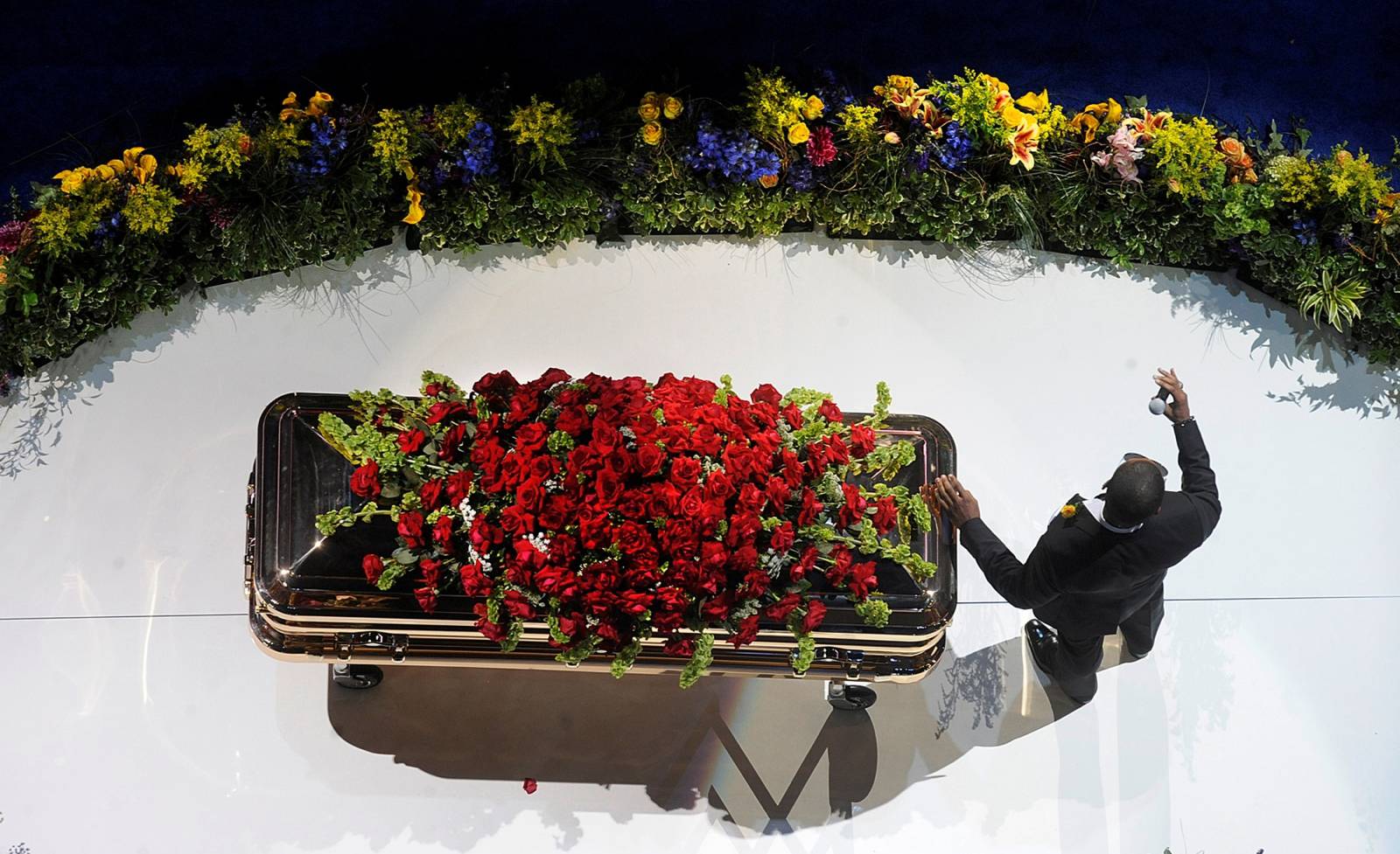 FILE PHOTO: R&B star Usher rests his hand on Michael Jackson's casket as he sings during the memorial service for Jackson at the Staples Center in Los Angeles