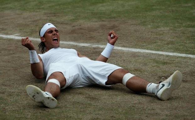 FILE PHOTO: Rafael Nadal reacts after winning his finals match against Roger Federer at the Wimbledon tennis championships in London