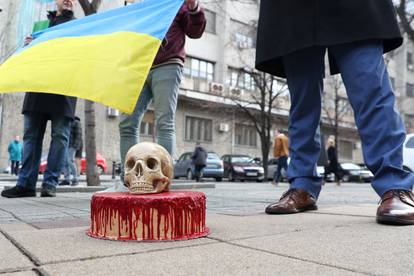 A pro-Ukrainian activists in Serbia delivers a bloody cake and a skull to police guarding Russian embassy in Belgrade