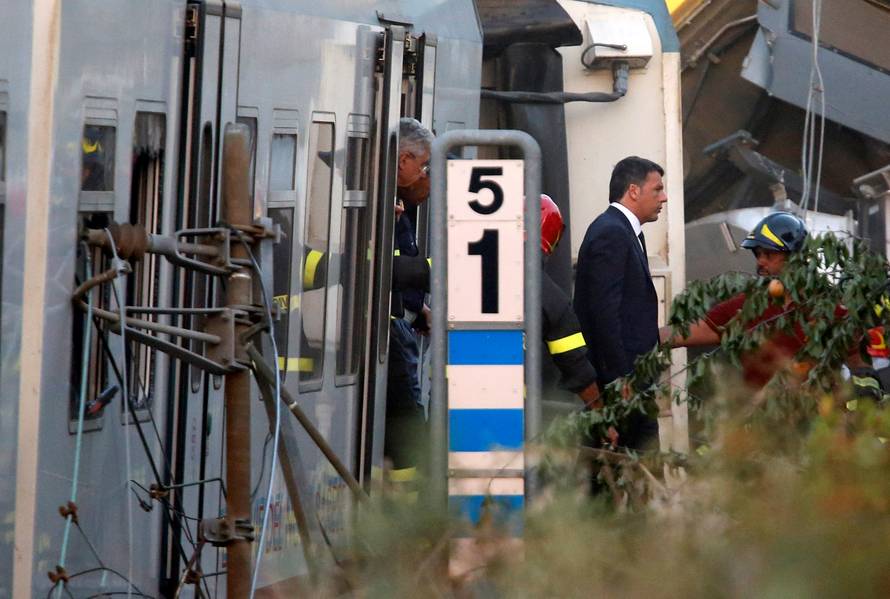 Italian Prime Minister Matteo Renzi walks at the site where two passenger trains collided in the middle of an olive grove in the southern village of Corato