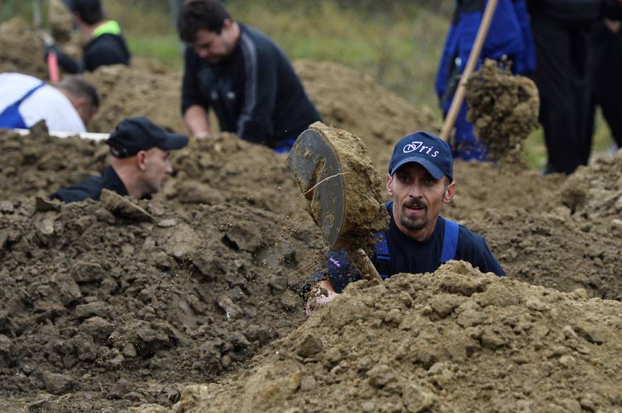 Gravediggers compete during a grave digging championship in Trencin