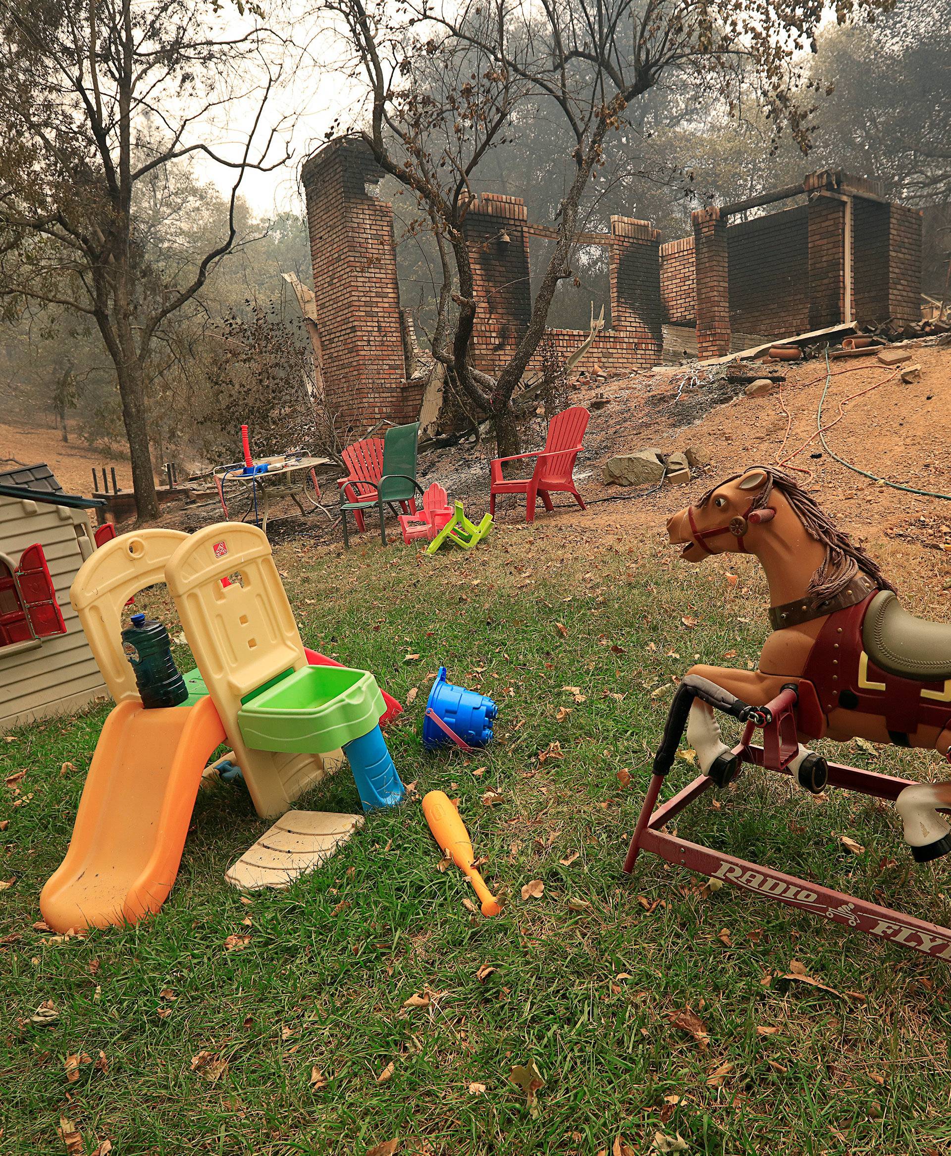 Toys stand untouched near a home destroyed by the Carr Fire west of Redding