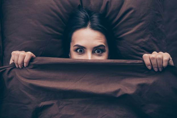 Close-up portrait of her she nice attractive lovely cheerful cheery funny childish girlish girl covering hiding face dark marsala burgundy maroon veil lying in bed in room flat house indoors