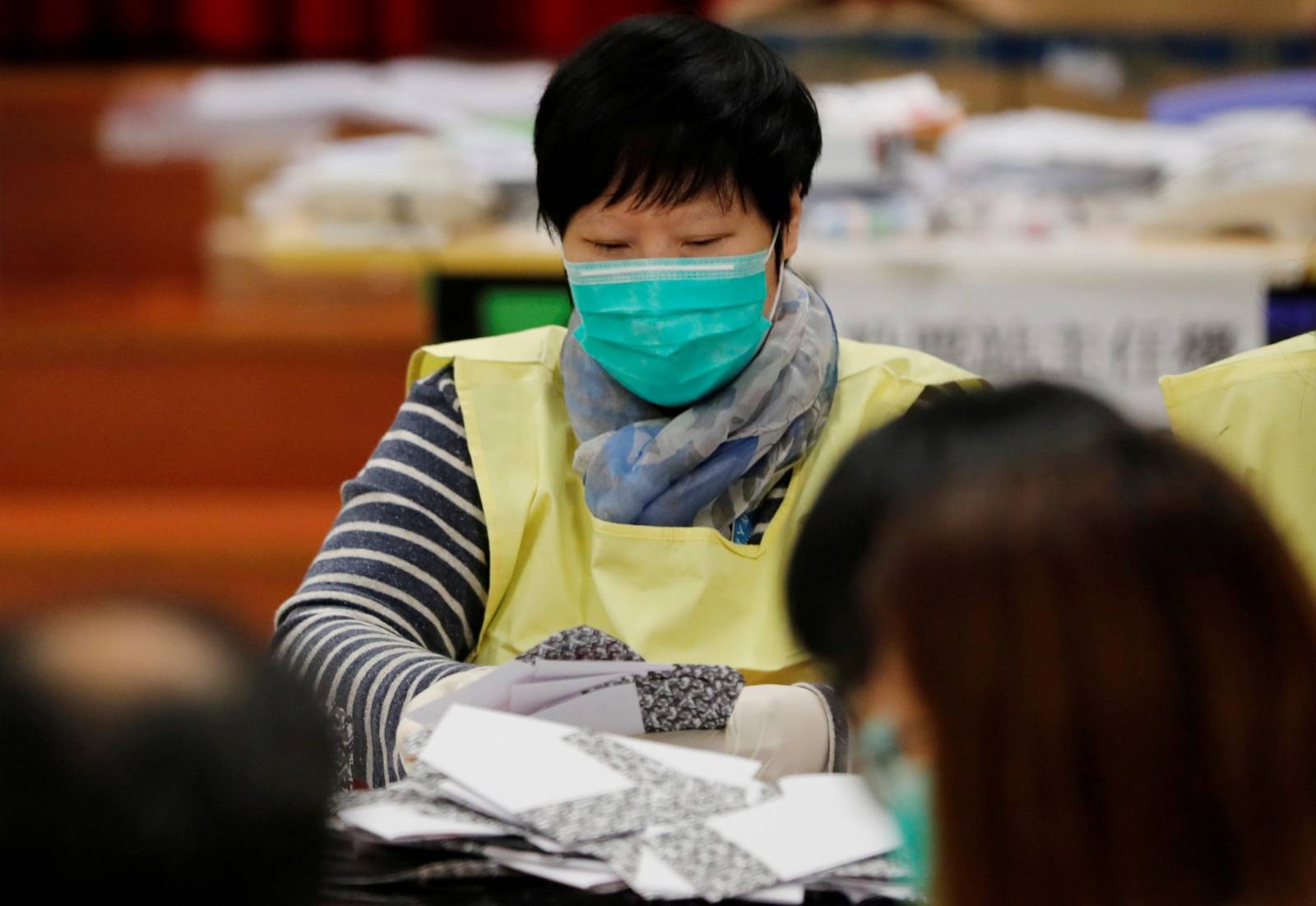 A polling official counts votes of the Hong Kong council elections, in a polling station in Hong Kong
