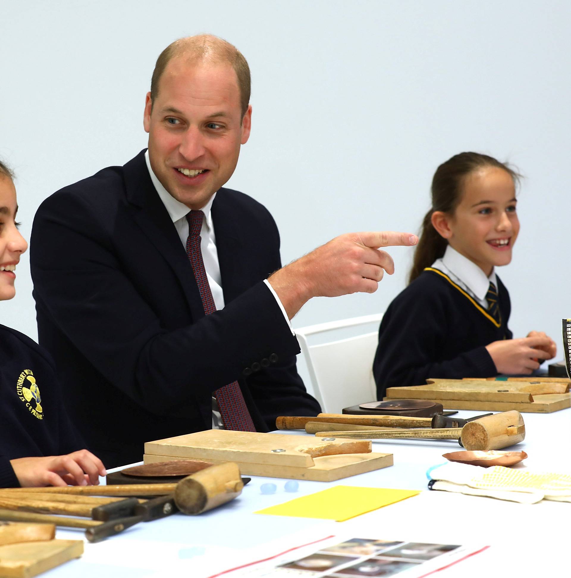 Britain's Prince William joins local school children from St Cuthbert with St Matthias CE Primary School at a copper beating workshop during the official opening of Japan House in London