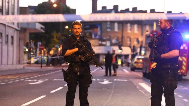 Police officers attend to the scene after a vehicle collided with pedestrians in the Finsbury Park neighborhood of North London