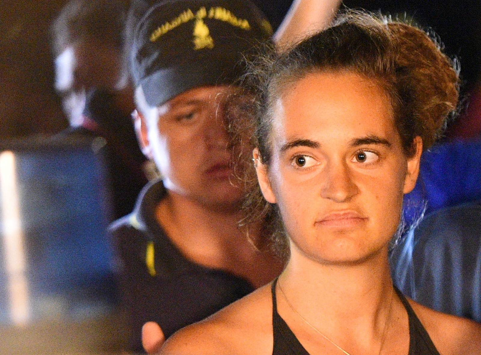 Sea-Watch 3 captain Carola Rackete is escorted off the ship by police and taken away for questioning, in Lampedusa