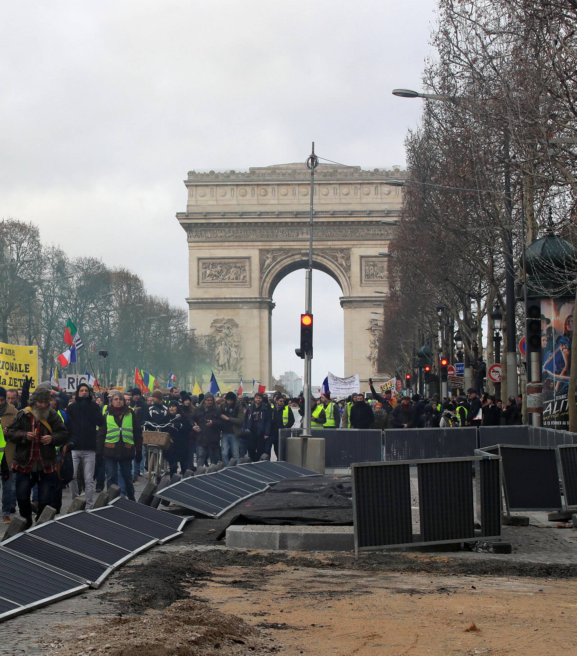 Protesters wearing yellow vests take part in a demonstration by the "yellow vests" movement in Paris