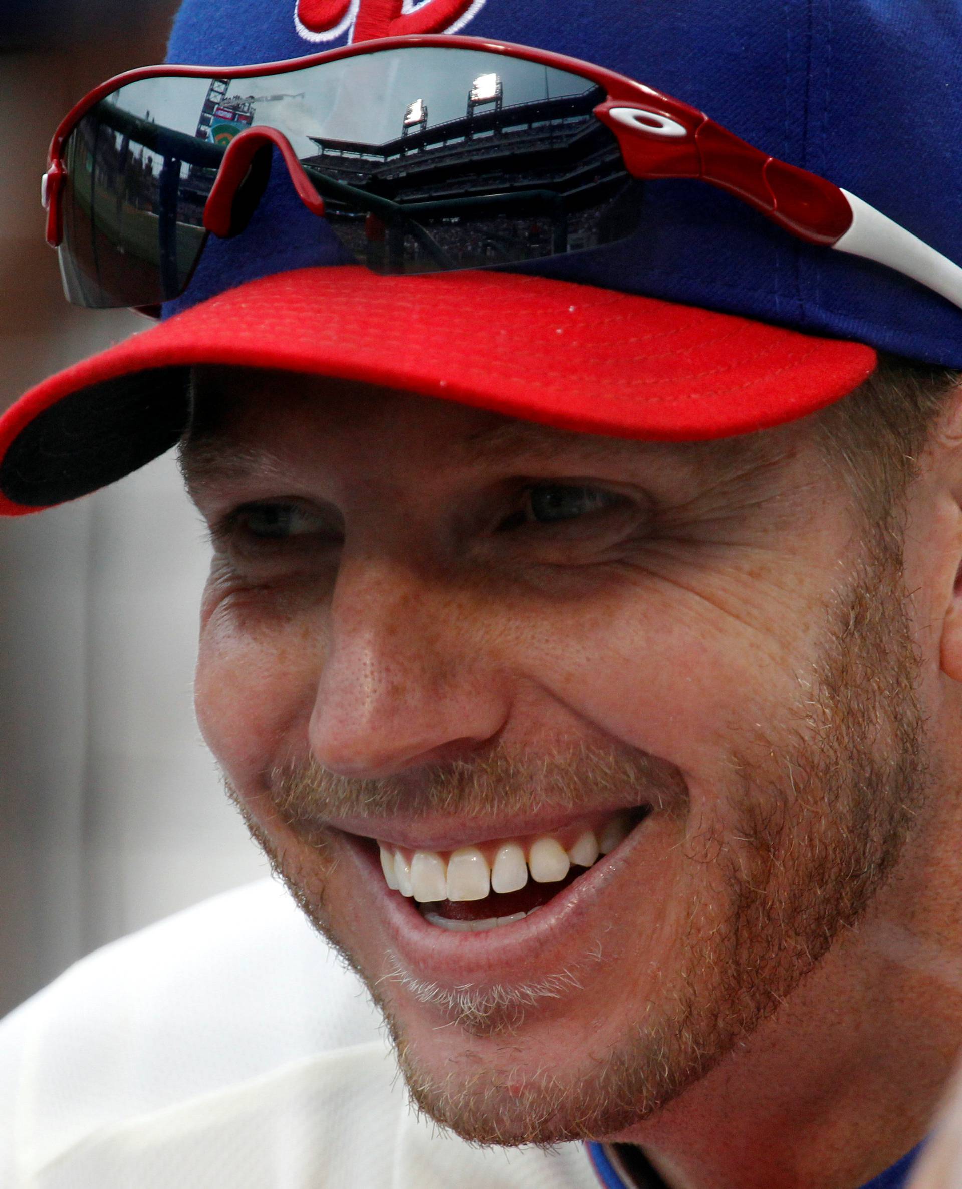 FILE PHOTO: Phillies' Halladay smiles while sitting in the dugout before their MLB National League baseball game against the Cubs in Philadelphia