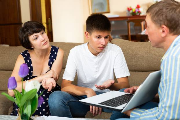 Young,Woman,With,Teenage,Son,Meeting,Financial,Advisor,For,Investment