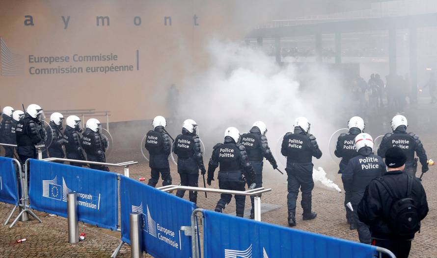 Police officers face off with far-right supporters during a protest against Marrakesh Migration Pact, outside European Commission headquarters, in Brussels
