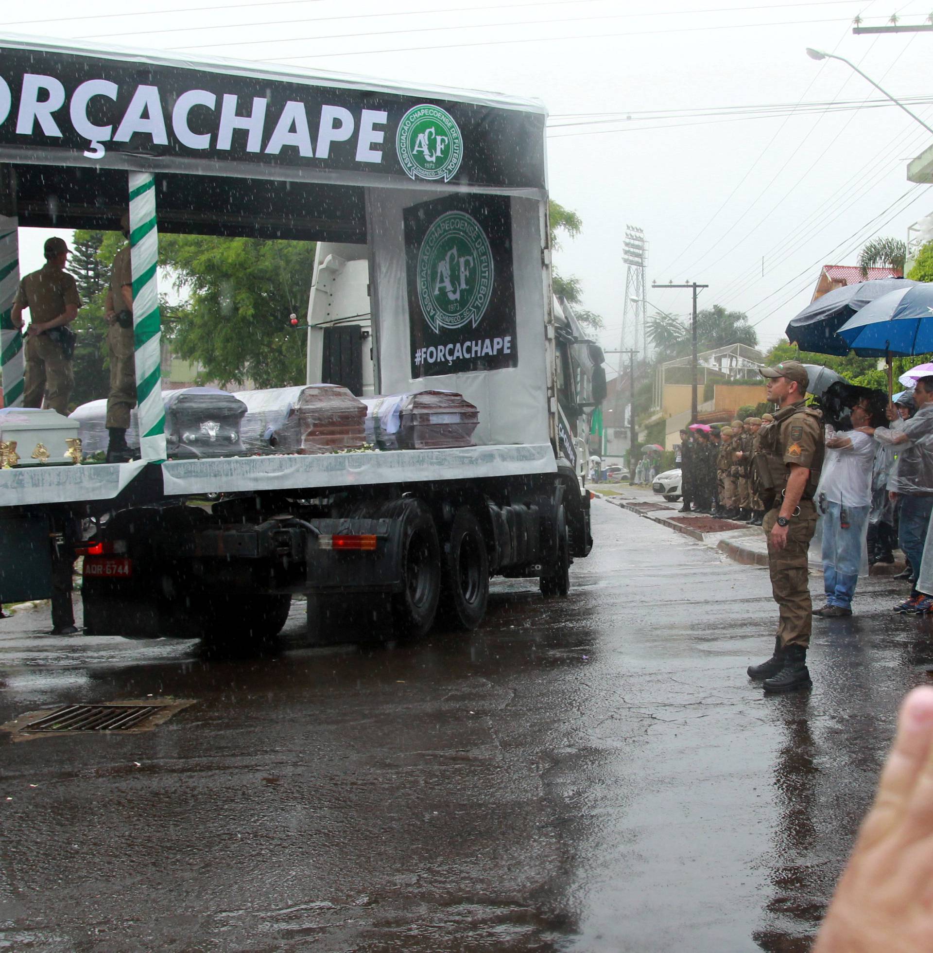 A residents of Chapeco waves during the procession through Chapeco's city of the victims of the plane crash in Colombia