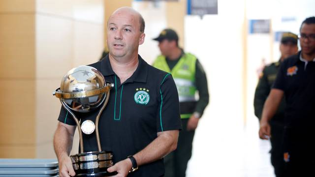 Marcelo Zolet, legal advisor to the Brazilian soccer team Chapecoense, carries a replica of the South American trophy after receiving from directors of Colombian club Santa Fe, the last Sudamericana Cup champion in Medellin