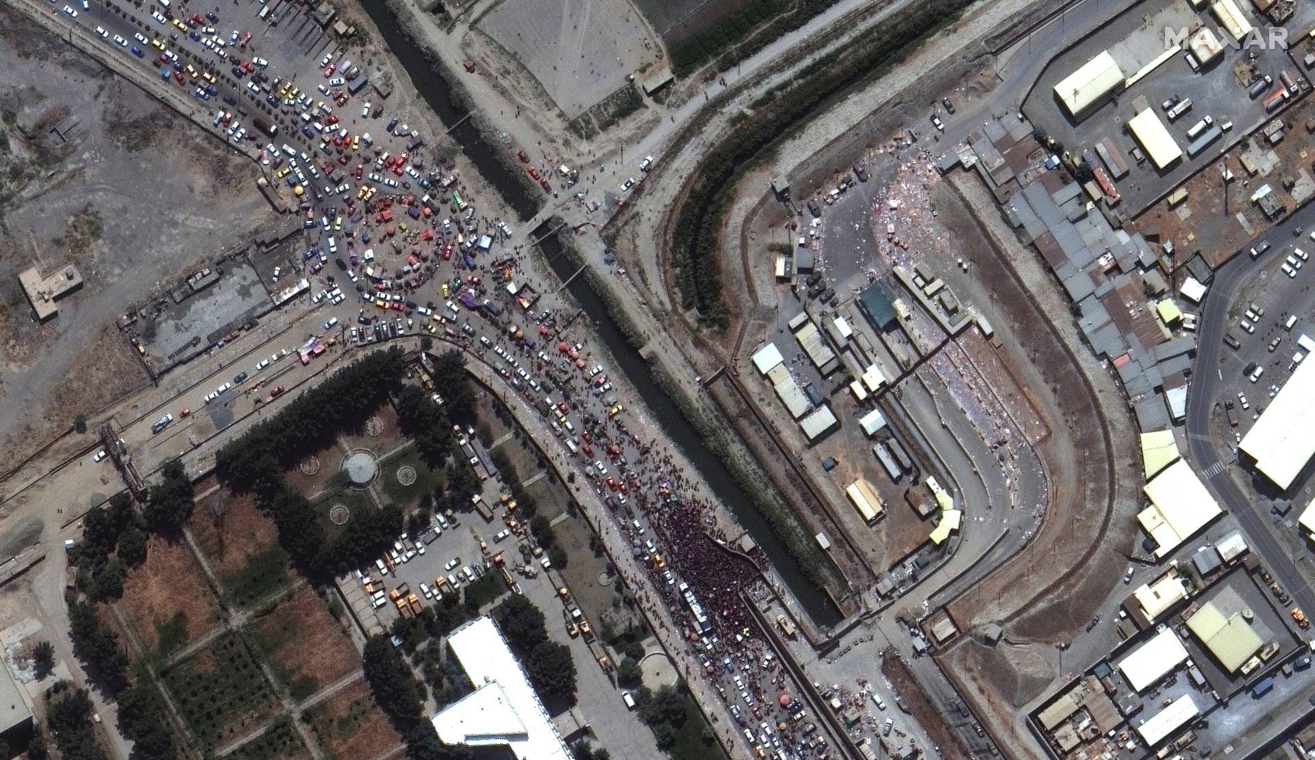 An overview of crowds at a gate to Kabul's airport