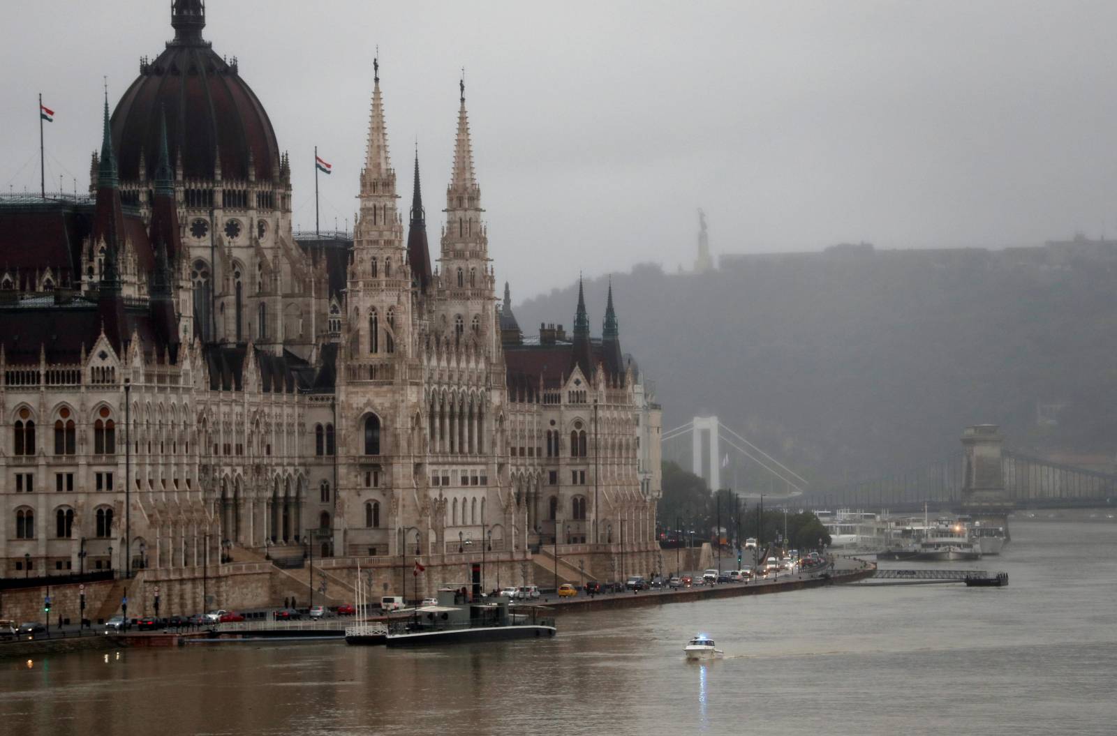 A police boat is seen on Danube river in front of the Hungarian Parliament in Budapest