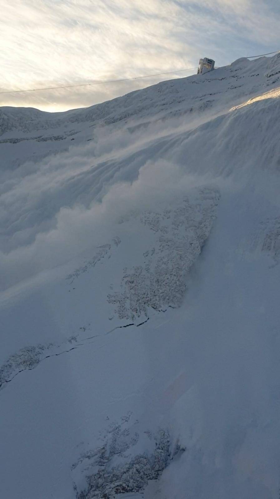 An avalanche after a controlled explosion is pictured at Glacier 3000 in Les Diablerets