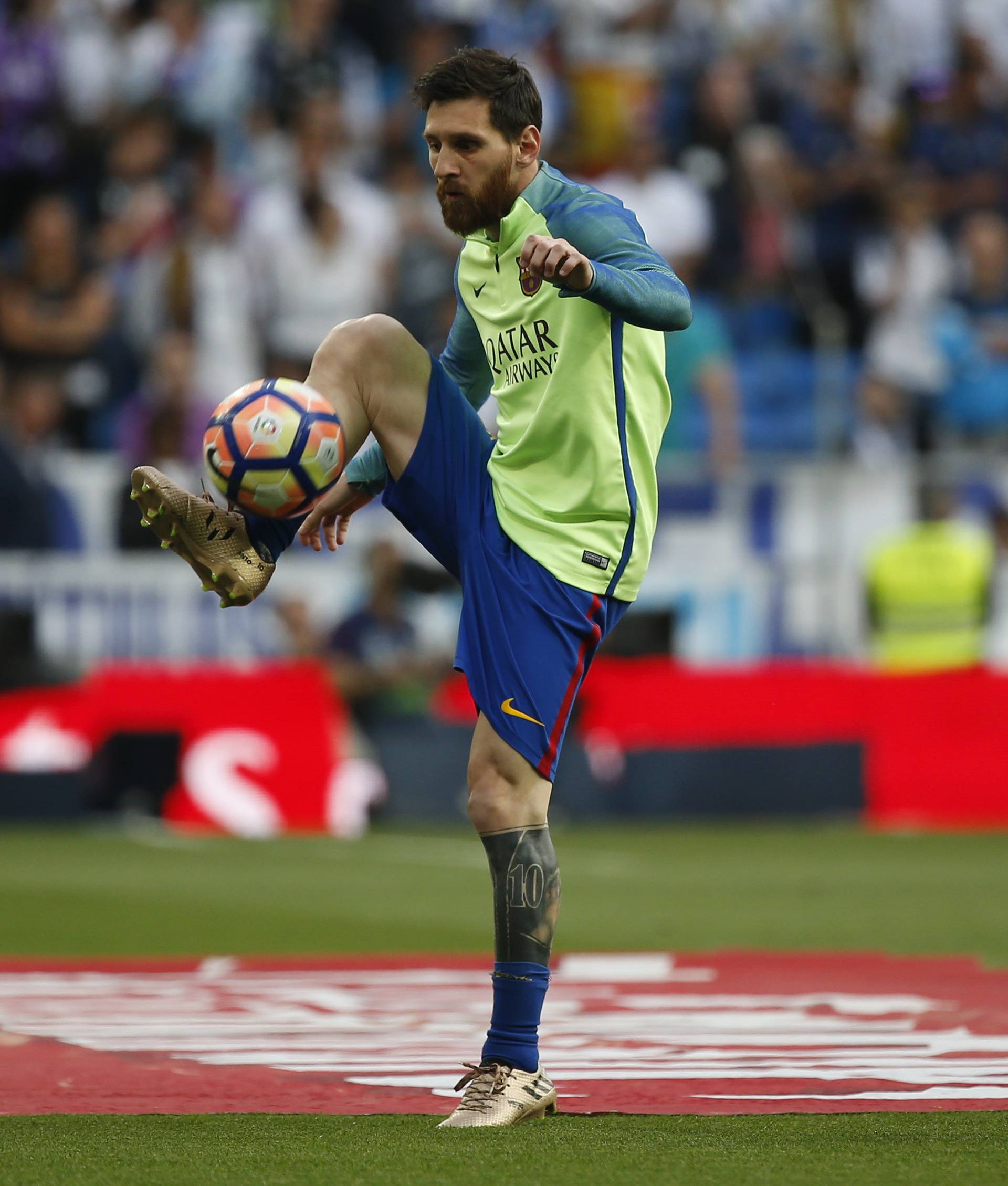 Barcelona's Lionel Messi warms up before the match
