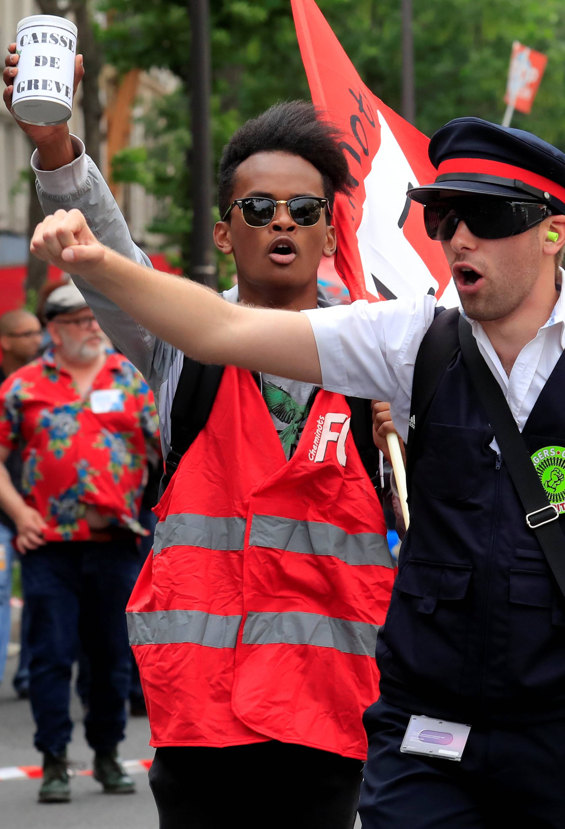 Protesters shout slogans during a demonstration by French unions and France Insoumise" (France Unbowed) political party to protest against government reforms, in Paris