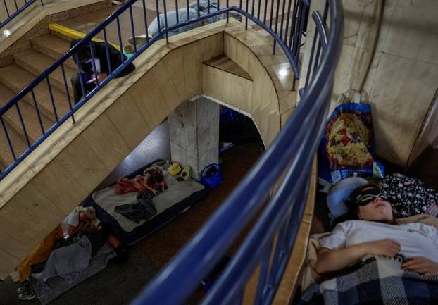 People take shelter inside a metro station during an air raid alert in Kyiv