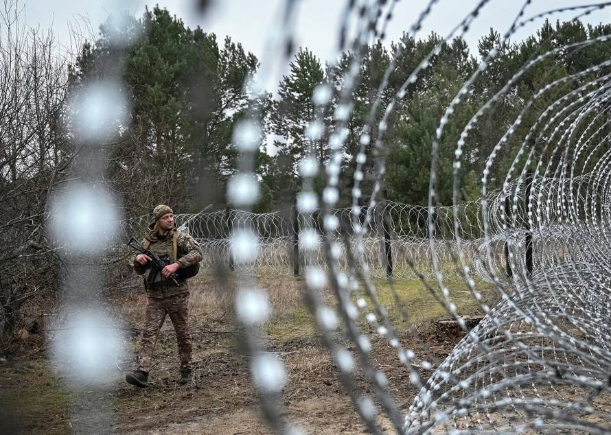 A member of the Ukrainian State Border Guard Service patrols along the Ukraine-Belarus border in Chernihiv region