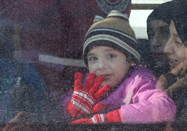 A child reacts from inside a bus evacuating people from a rebel-held sector of eastern Aleppo