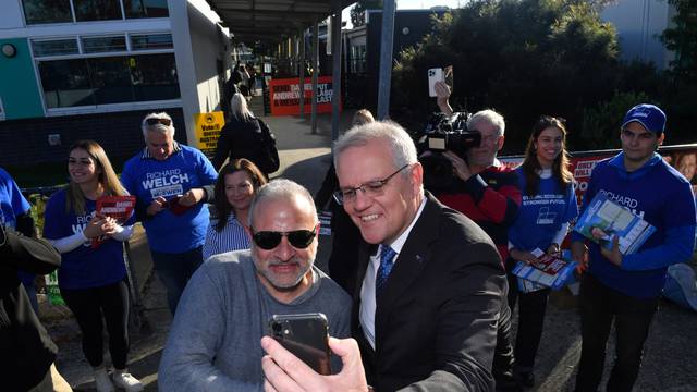 Australia's Prime Minister Scott Morrison takes a selfie at the Laurimar Primary School on Federal Election day, in Doreen