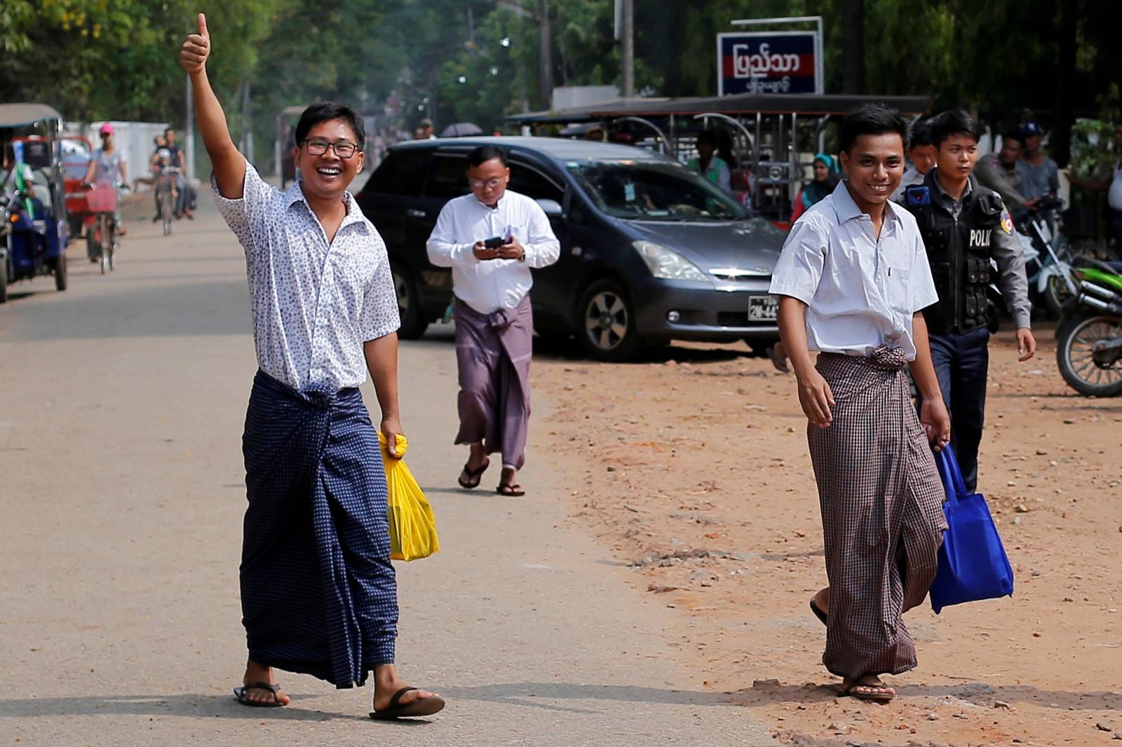 Reuters reporters Wa Lone and Kyaw Soe Oo gesture as they walk free outside Insein prison after receiving a presidential pardon in Yangon