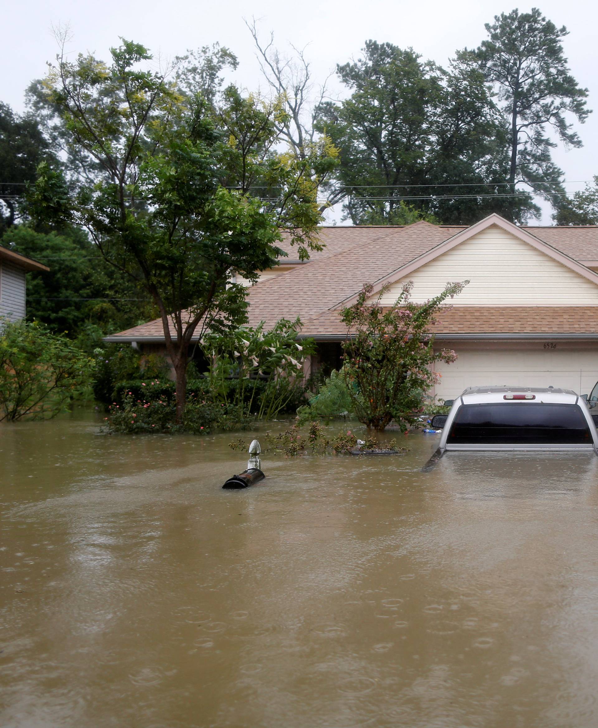 Houses and cars are seen partially submerged by flood waters from tropical storm Harvey in east Houston