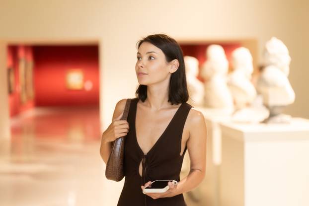 Young woman at a sculpture exhibition
