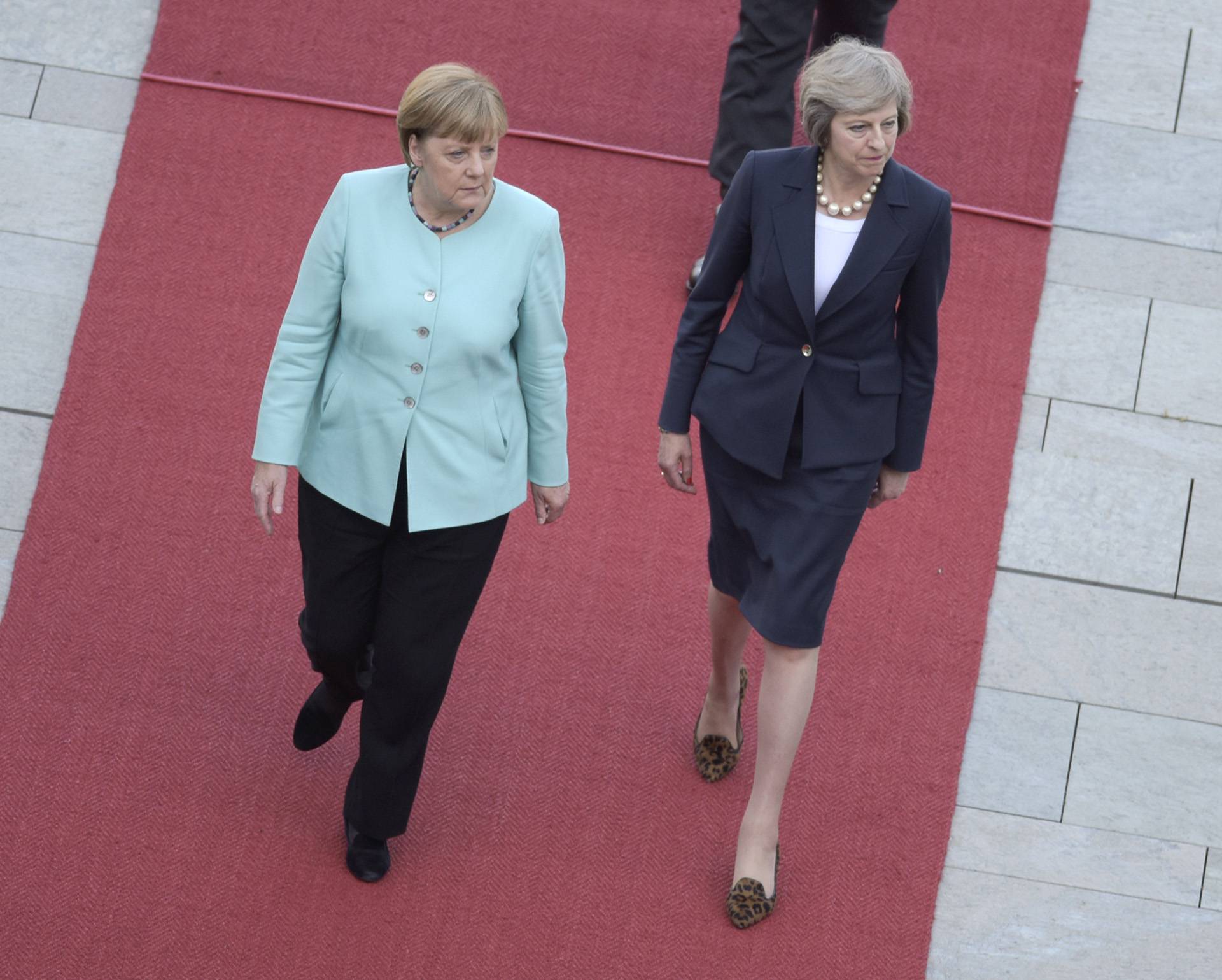 German Chancellor Merkel and Britain's Prime Minister May review honour guard in Berlin