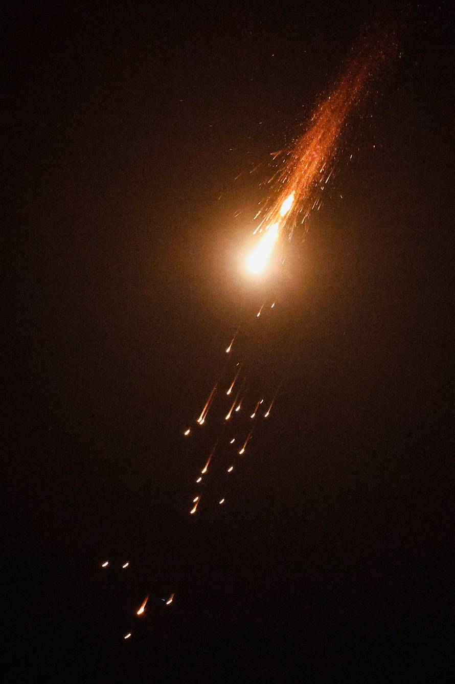 Streaks of light illuminate the sky during an interception attempt, as seen from Ashkelon