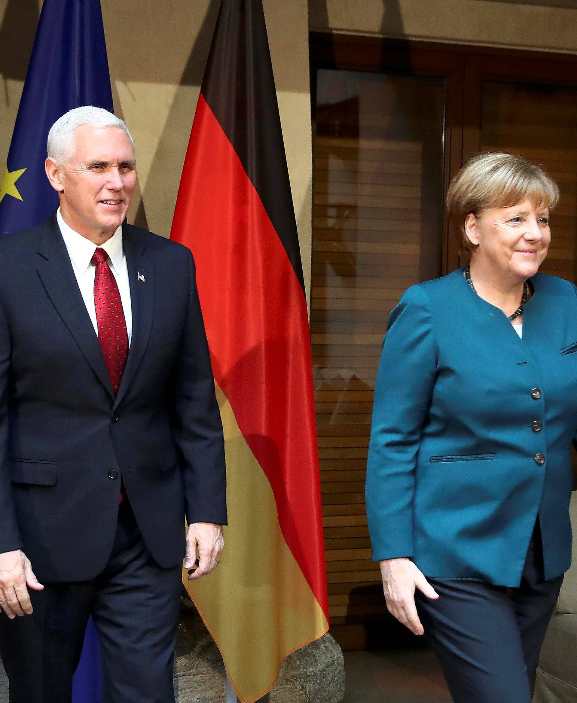 German Chancellor Merkel walks with U.S. Vice President Pence before their meeting at the 53rd Munich Security Conference in Munich