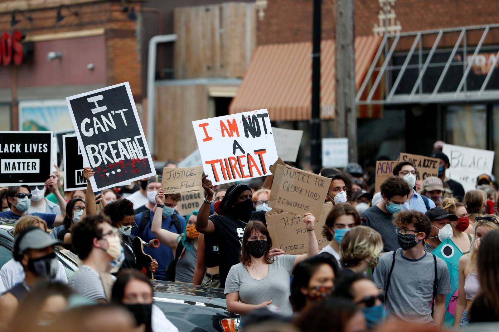 Protesters gather at the scene where Floyd was pinned down by a police officer in Minneapolis