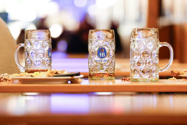 Empty beer mugs and plates are left on table at the end of the world’s biggest beer festival, the 189th Oktoberfest in Munich