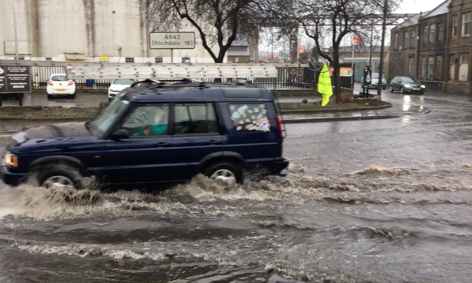 A car drives through a flood water during Storm Ciara in Brighouse