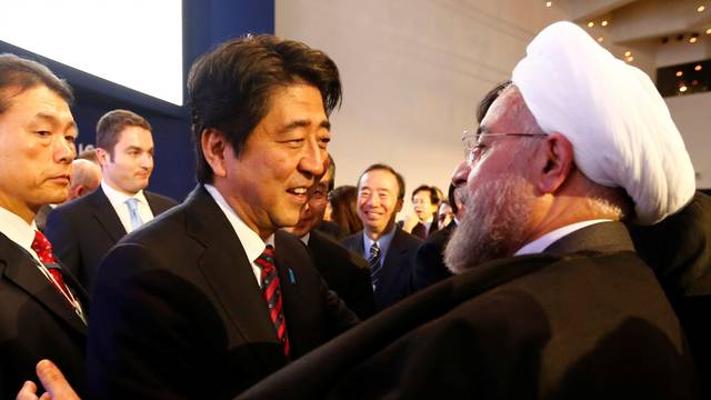 FILE PHOTO: Japan's Prime Minister Abe greets Iran's President Rouhani  at World Economic Forum in Davos
