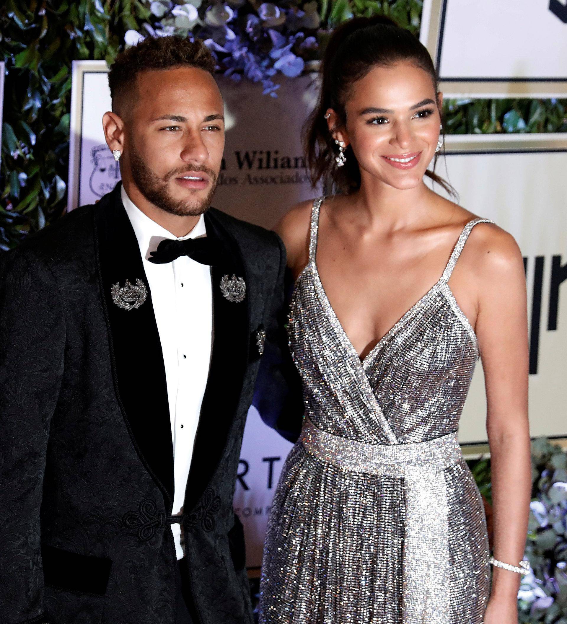 Soccer player Neymar and his girlfriend Bruna Marquezine pose on the red carpet during an auction to raise funds for his Institute Project Neymar Jr in Sao Paulo