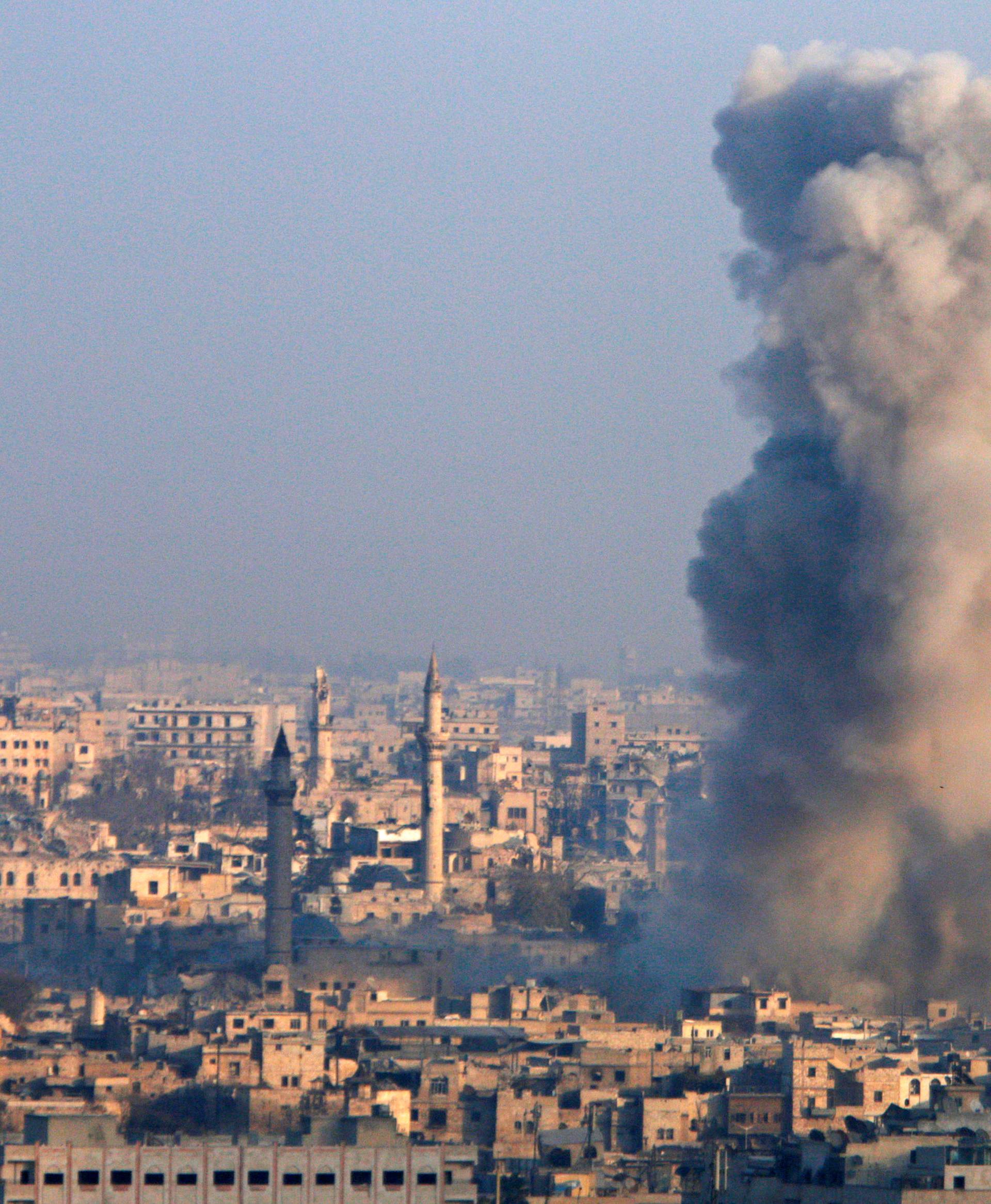 Smoke rises as seen from a government-held area of Aleppo