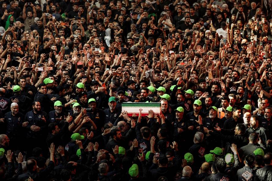 Mourners carry the coffins of family members of Iran’s late Supreme Leader Ayatollah Ali Khamenei, inside the shrine of Imam Abbas during funeral ceremonies in Karbala